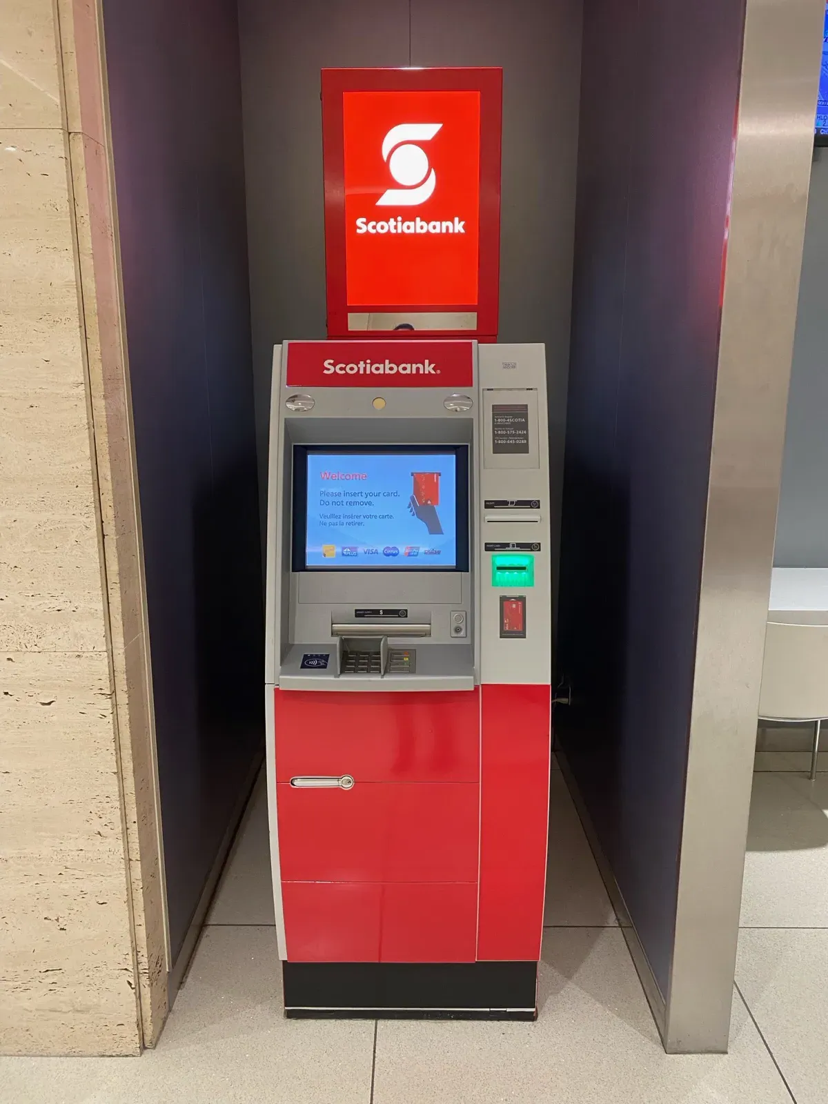 Illuminated Scotiabank topper above a lobby ATM